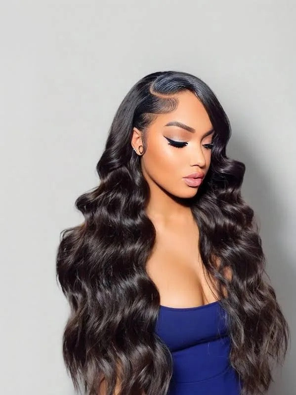 Woman with long, wavy Body Wave Virgin Human Hair Bundle Near Atlanta  wearing a blue top against a gray background