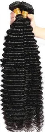 Three bundles of curly premium virgin human hair extensions held by a hand of Best Sew In hair styiist near buckhead against a neutral background